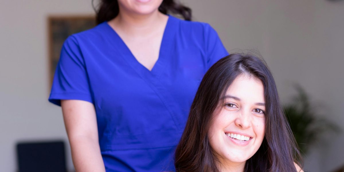 A patient care technician providing compassionate, hands-on support to a patient.